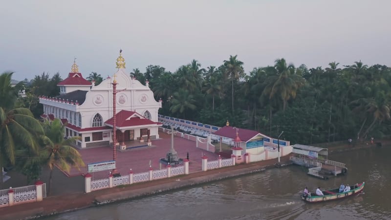 Boat tour past temple on Kerala backwaters at Alleppey, India. Aerial drone view