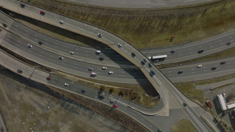 Top down footage of busy highway interchange. Multilane and multilevel crossroad with heavy traffic. Boston, USA