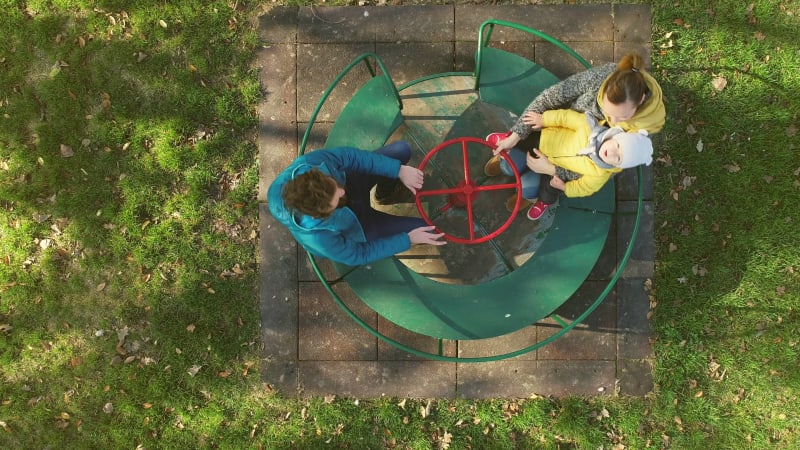 Aerial view of family enjoying day at the public playground.