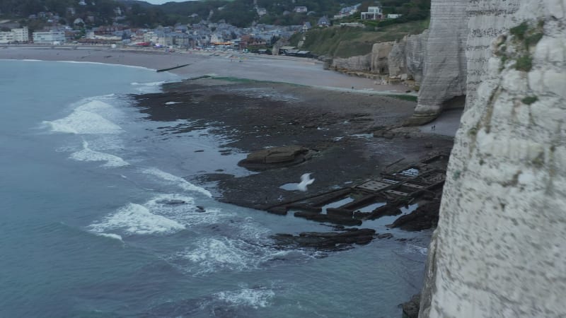 Close Up of Etretat Cliff Arch in France with Ocean View and seagull jumping off Rock