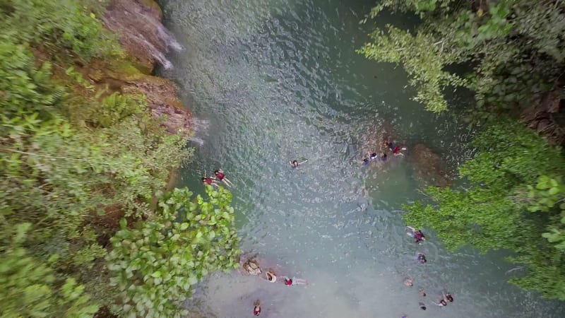 Aerial view of woman swimming in pool by Kawasan Falls in Alegria.