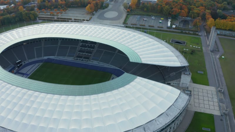 Olympiastadion in Berlin, Germany with no people during Coronavirus Covid 19 Pandemic, Aerial Wide Shot Dolly slide right establishing shot, October 2020