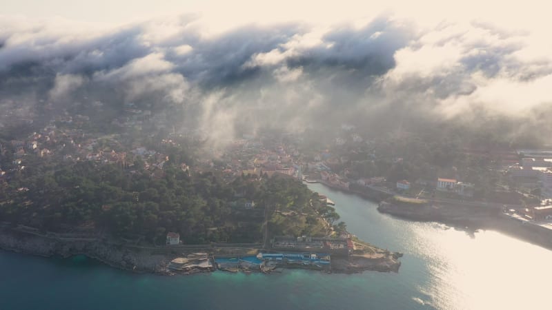 Aerial view above the clouds of Veli Lošinj cityscape.