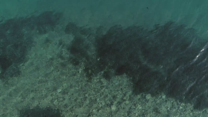 Aerial view of a wooden deck in the mediterranean sea.