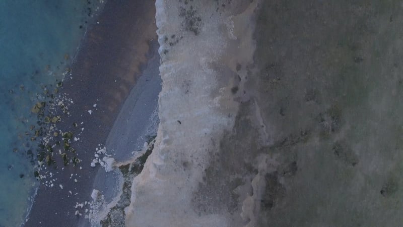 Bird's Eye View Looking Down from a High Cliff Edge to the Sea Below