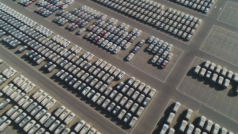 Faraway aerial view of group of cars at parking space on a desert landscape.