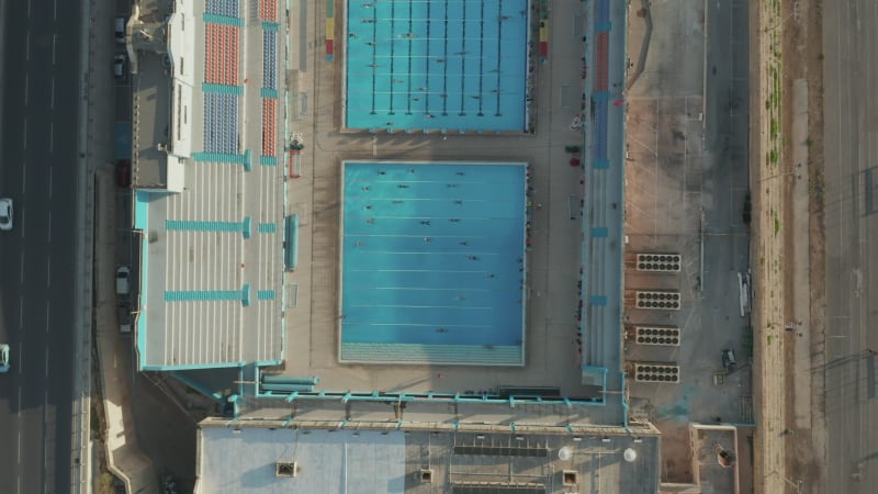 Swimming Pool with Swimmers training doing lanes, Sunshine