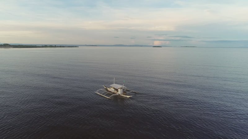 Aerial view of single filipino fishing boat near Lapu-Lapu city.