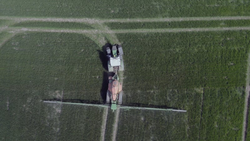 Tractor Spraying a Controversial Glyphosate Herbicide on Agricultural Land