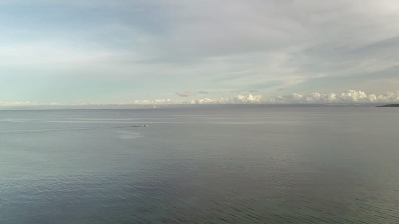 Aerial view single boat sailing near Lapu-Lapu city.