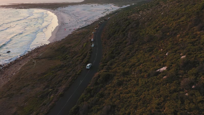 Aerial view of road crossing Scarborough Beach at sunset.