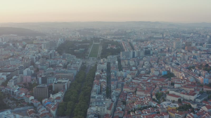 Wide panoramic aerial view of Lisbon city center with colorful residential houses and large green public park