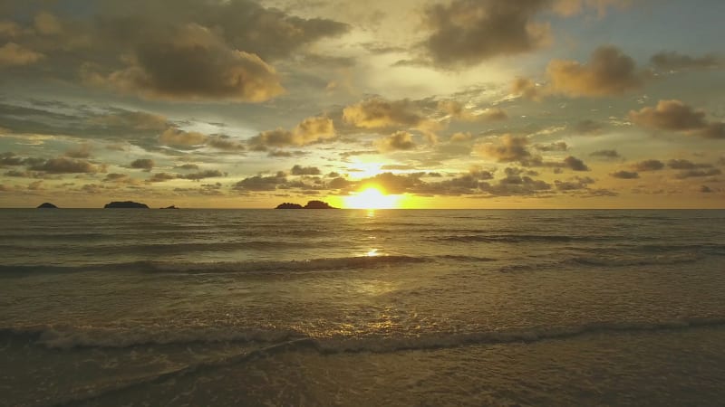 Aerial view of a woman taking a photo of scenic sunset, Ko Chang.