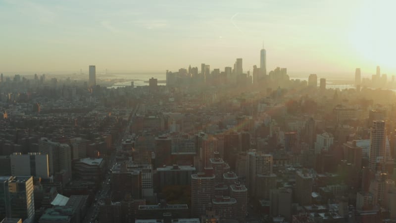 Urban neighbourhood from height. Aerial panoramic view of cityscape against sunset. Manhattan, New York City, USA