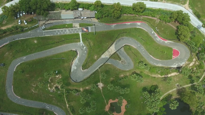 Aerial view above of a group driving kart on a speedway.