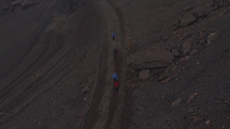 Overhead view four backpacker traveler walking pathway trekking in Iceland. Top down view adventurous people hikers exploring isolated icelandic land