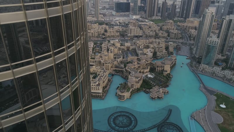 Aerial view of Burj Khalifa skyscrapers and turquoise pool.