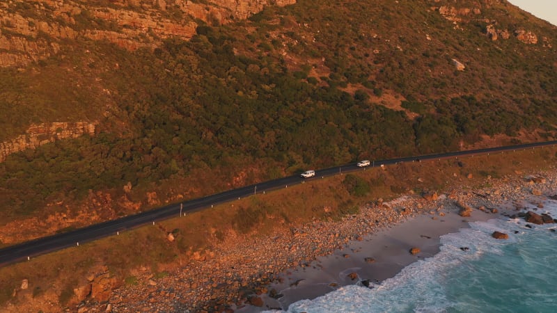 Aerial view of road zigzagging at Chapmans Peak during sunset.