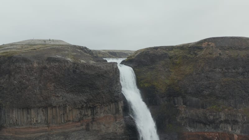 Drone orbiting around the jump of the famous Haifoss waterfall in south Iceland. Aerial view of spectacular famous travel destination Haifoss cascade. Beauty on earth. Haifoss waterfall