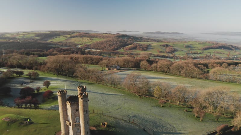 Broadway Tower, a famous iconic tourist attraction in The Cotswolds Hills, iconic English landmark with beautiful British countryside scenery in mist, Gloucestershire, England, UK