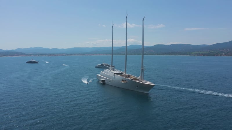 Aerial view of a yacht and many boats along the coast, France.