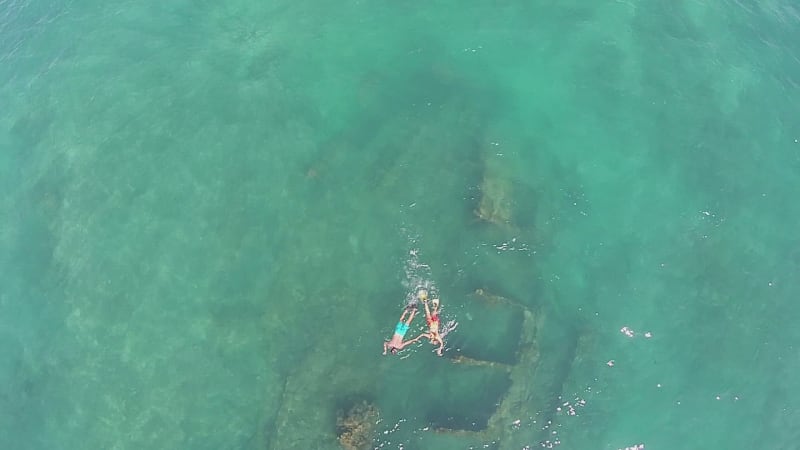 Aerial view of a couple snorkeling on a shipwreck, Baja California Sur