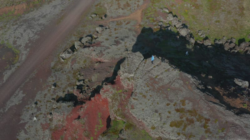 Overhead view two climbers standing top hill in Iceland. Top down view two hikers enjoying panorama climbing cliff