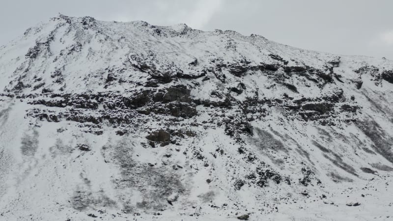 Snow White Mountain with Black Rocks in Iceland Winter, Snowing, Cold, Arctic