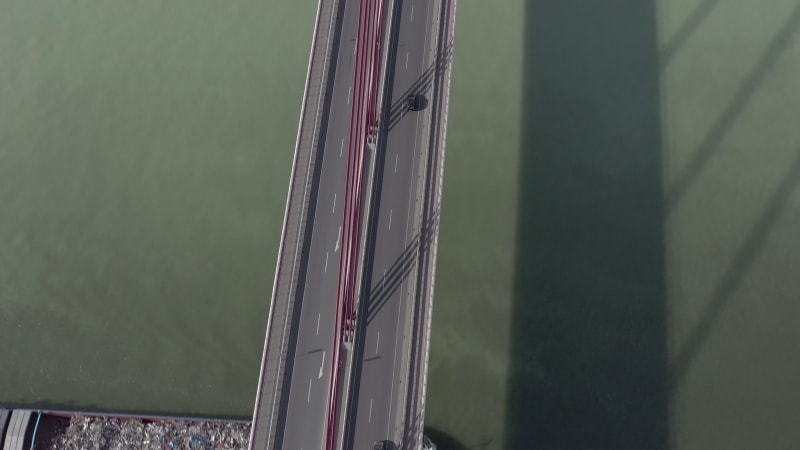 Vehicles Crossing a Cable Stayed Suspension Bridge Crossing a River