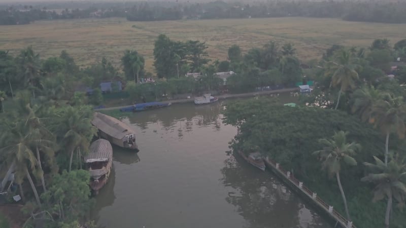 Large houseboats on the river in small Indian village