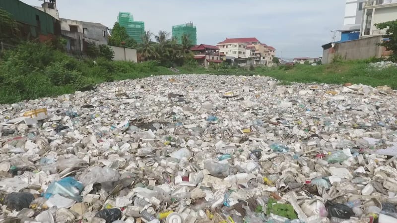 Aerial view of river with a high concentration of trash.