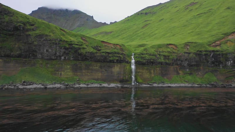 Aerial view of a waterfall at Driftwood Bay, Unalaska, Alaska, United States.