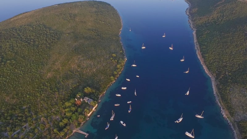 Aerial view of boats anchored at bay during the sunset.