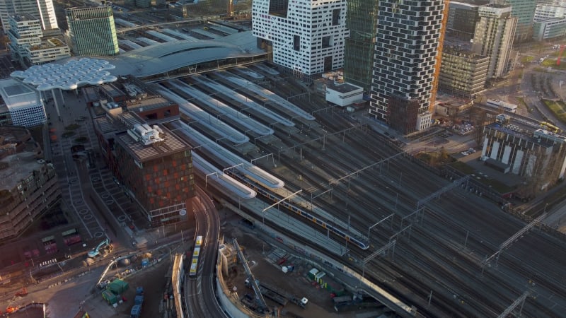 Aerial Drone footage revealing train entering central station at the city center in Utrecht, Netherlands