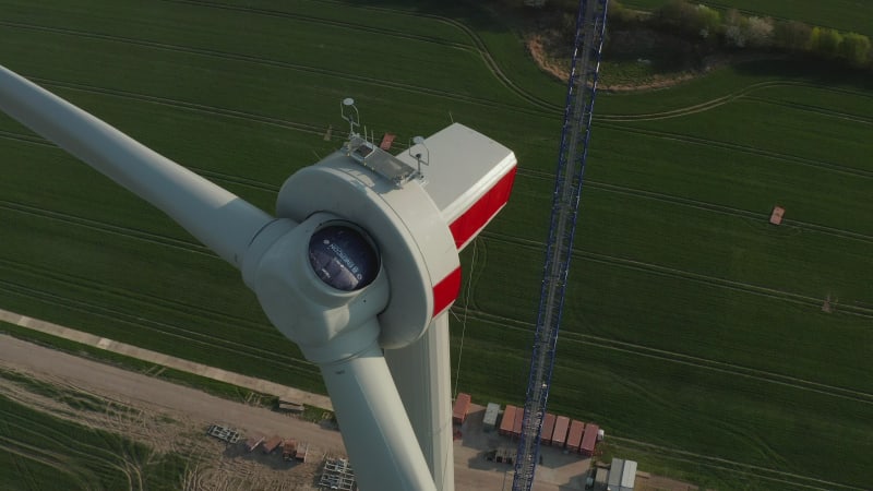 Close up of Wind Turbine under construction being built on rich green agriculture field