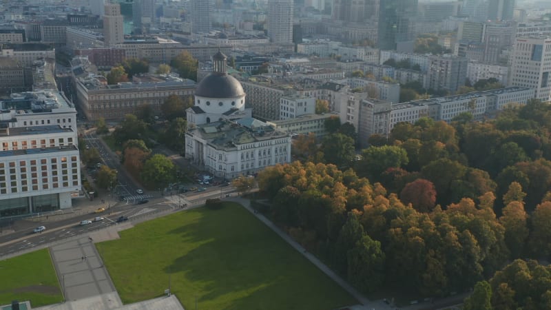 High angle view of Pilsudski Square corner with surviving part of Saxon Palace. Revealing church with dome and downtown high rise buildings. Warsaw, Poland