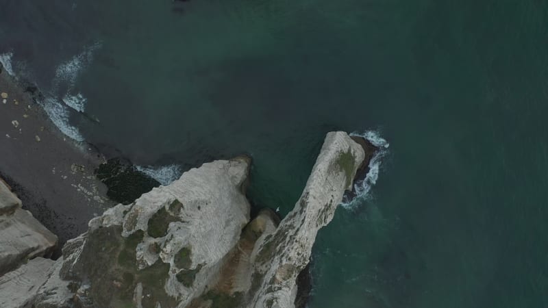 Overhead Top Down Birds Eye Aerial View of Etretat Cliffs in France with Waves and Birds Flying by