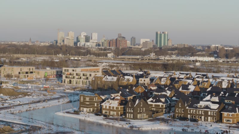 Aerial view of outskirts of downtown Utrecht covered in snow with frozen water canals