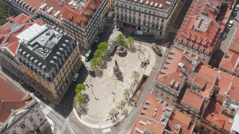 Drone camera flying around stone Jesus statue. Evening view of Christ the King Sanctuary in Almada over Tegus rives in setting sun. Lisbon, capital of Portugal.