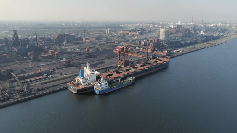 Bulk Carrier Ship Offloading Cargo at an Industrial Port in Europe