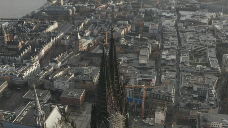 High angle view of top of two richly decorated gothic towers of Cathedral Church of Saint Peter high above city. Cologne, Germany