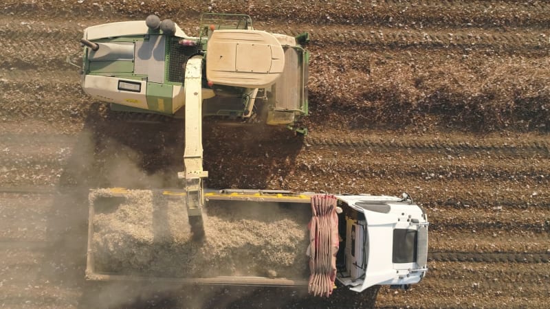 Aerial view of a tractor and a lorry working in a field, Kibbutz Saar, Israel.