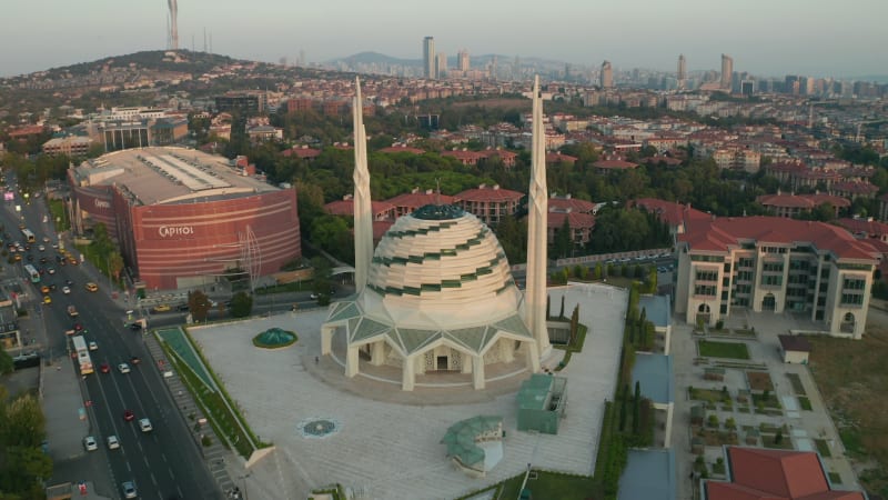 Futuristic Mosque in Istanbul, Modern looking Temple at Sunset with Cityscape, Aerial forward