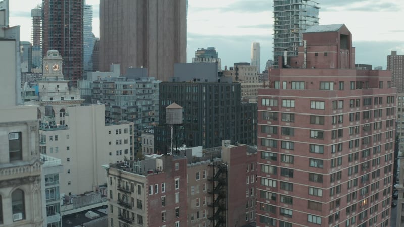 Aerial footage of various buildings in urban neighbourhood. Rectangular street network with apartment buildings. Manhattan, New York City, USA