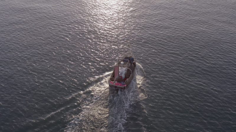 Fishing Boat in the Early Morning Heading Out to Sea