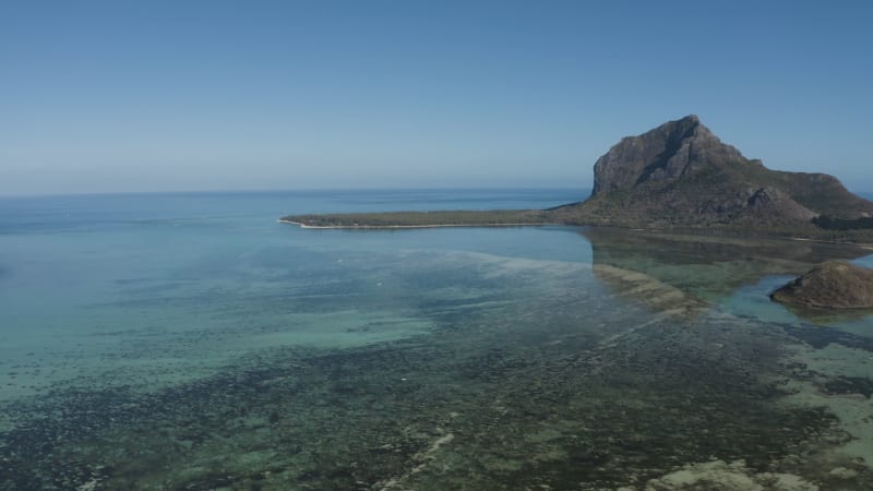 Aerial view of a water airplane landing in a lagoon with barrier reef with Le Morne Mountain in background, Le Morne Bramant, Riviere Noire, Mauritius.