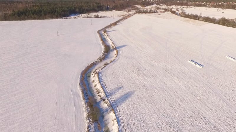 Aerial view of Vaana Jogi river surrounded by snow in winter.