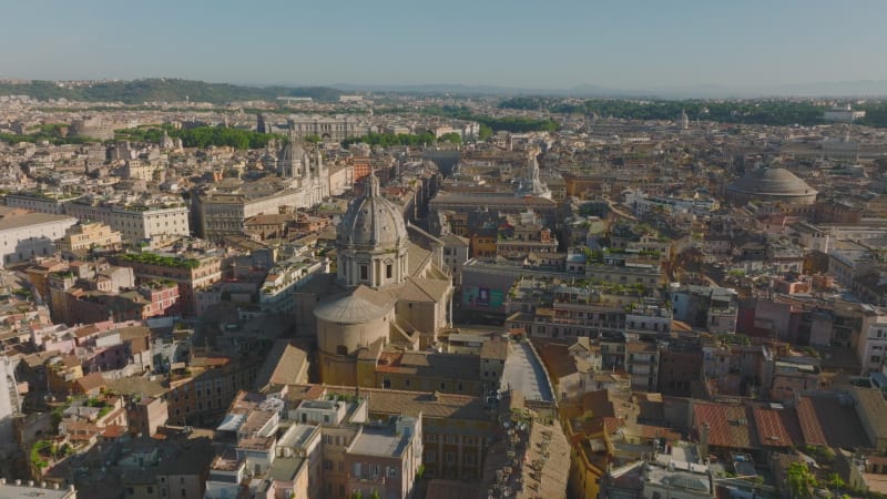 Aerial view of historic tourist sights in city centre. Towers and domes of churches and basilicas, buildings lit by sunshine. Rome, Italy