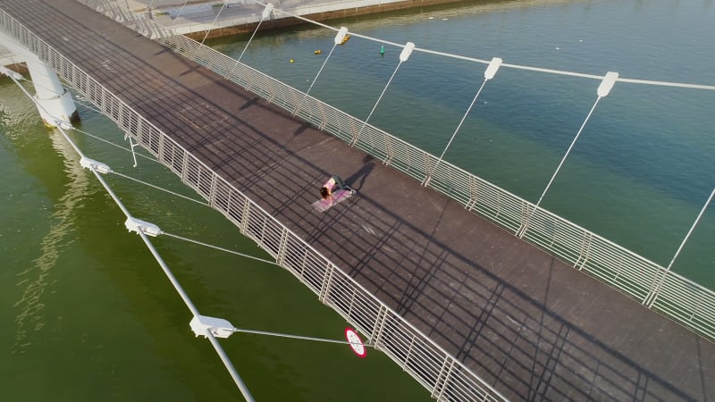 Aerial view of woman doing exercise in bridge on Abu Dhabi