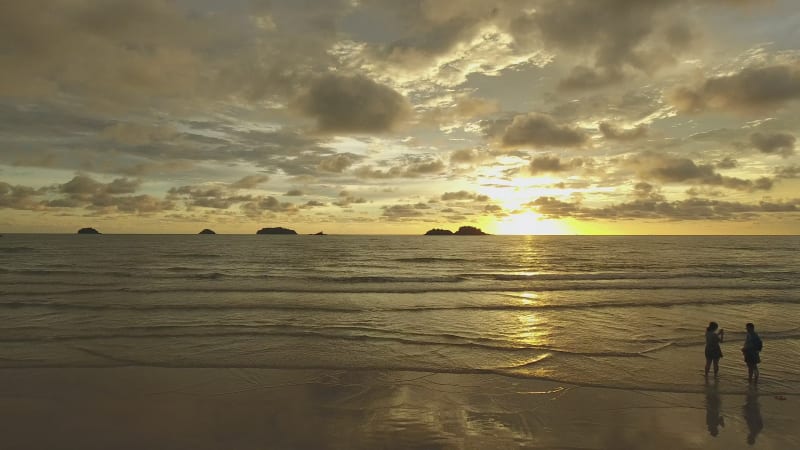 Aerial view of a calm tropical beach during orange sunset, Ko Chang.